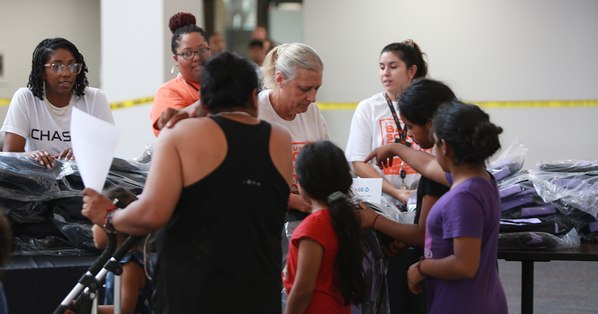 Pictured: Volunteers hand out backpacks in OSU-Tulsa's Main Hall for the fifth annual Community Back to School Bash.