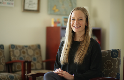 Grace Evans sits in chair smiling