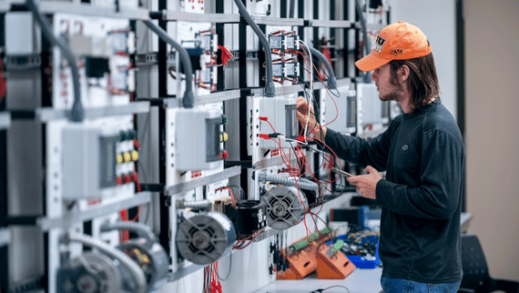 A male student works on an instrumentation panel.