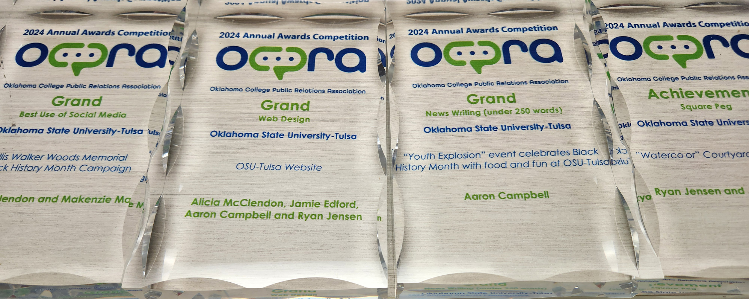 OCPRA clear acrylic award trophies lined up for an artistic banner image