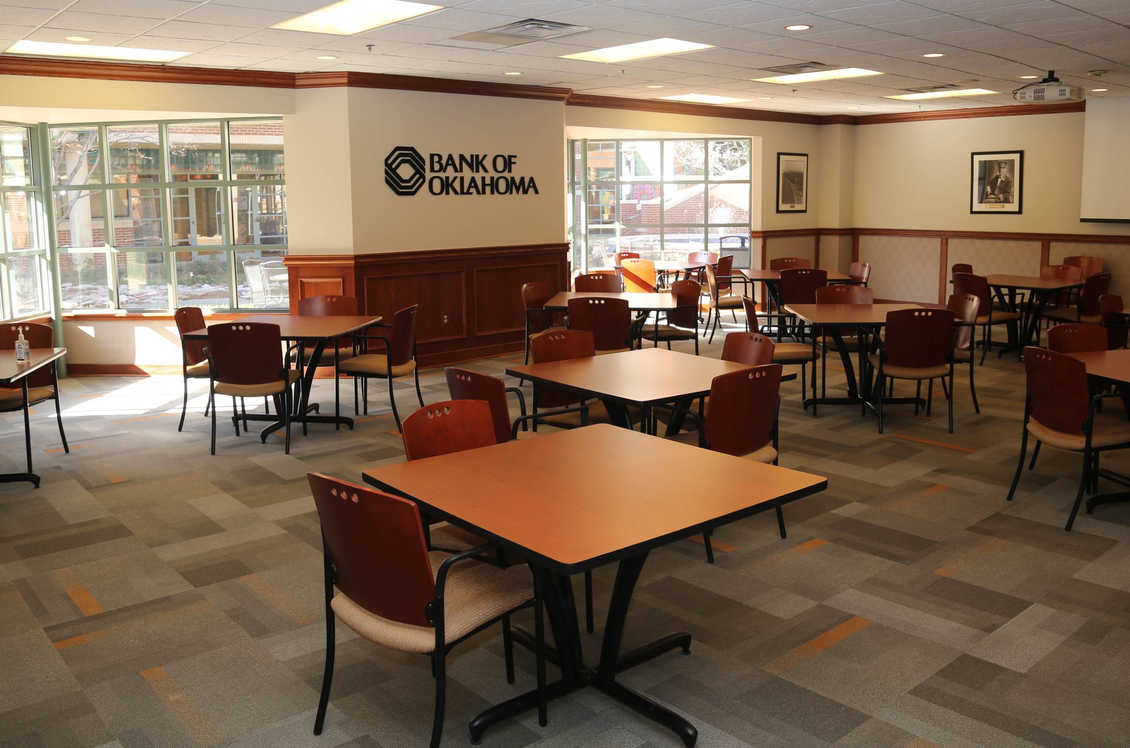 bokroom.jpg BOK room set up with empty square tables with four chairs per table.