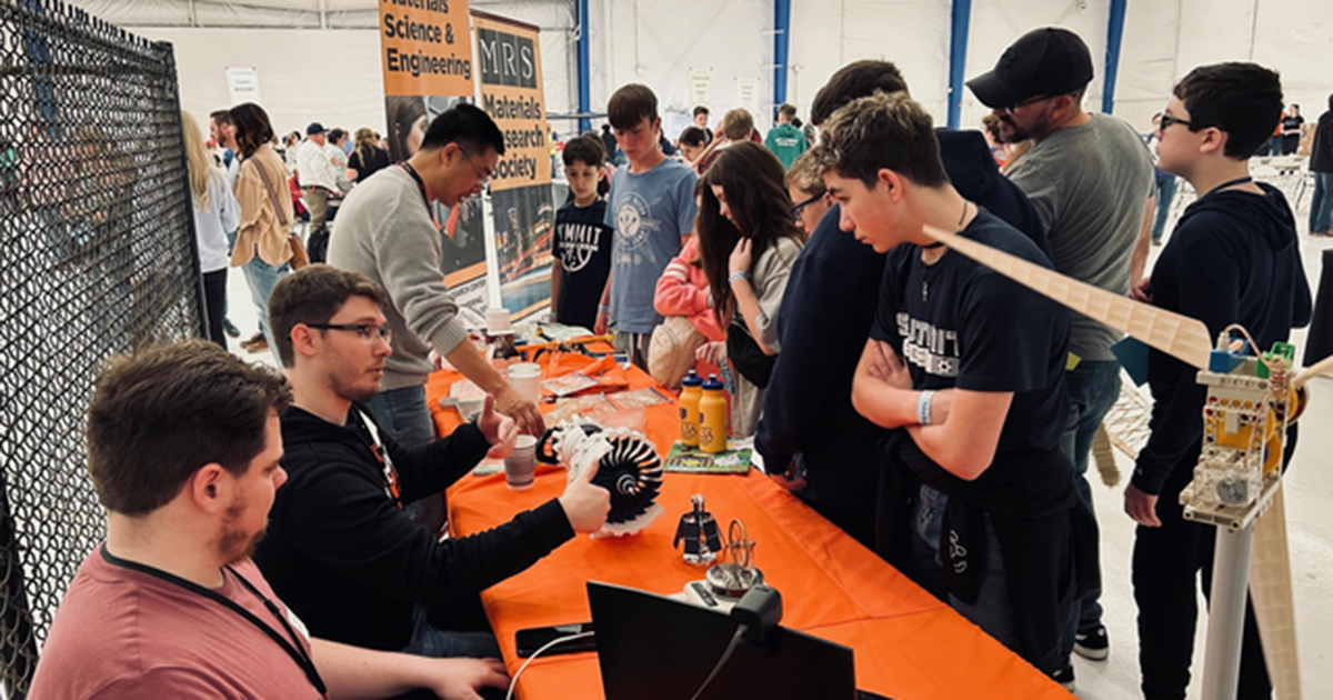 the OSU-Tulsa team of student and faculty engineers helps a crowd of K-12 students engage with STEM topics at the Tulsa Engineering Challenge.